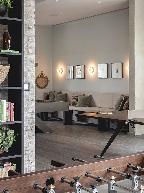 Inviting lounge area with cozy seating, elegant decor, and a stylish bookshelf, perfect for relaxation and entertainment.