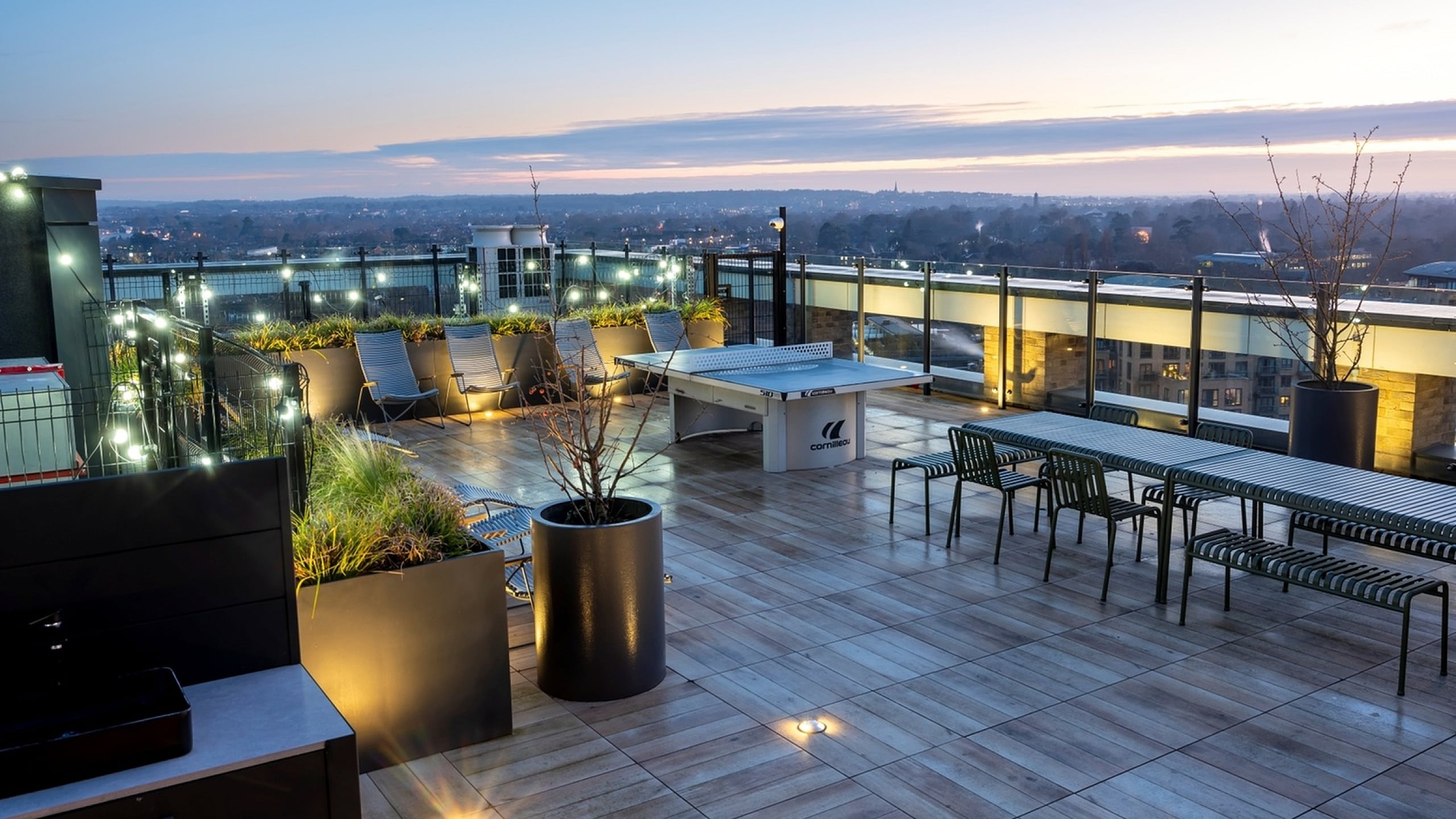 Luxurious rooftop terrace with elegant seating and stunning sunset views, ideal for entertaining and relaxation.
