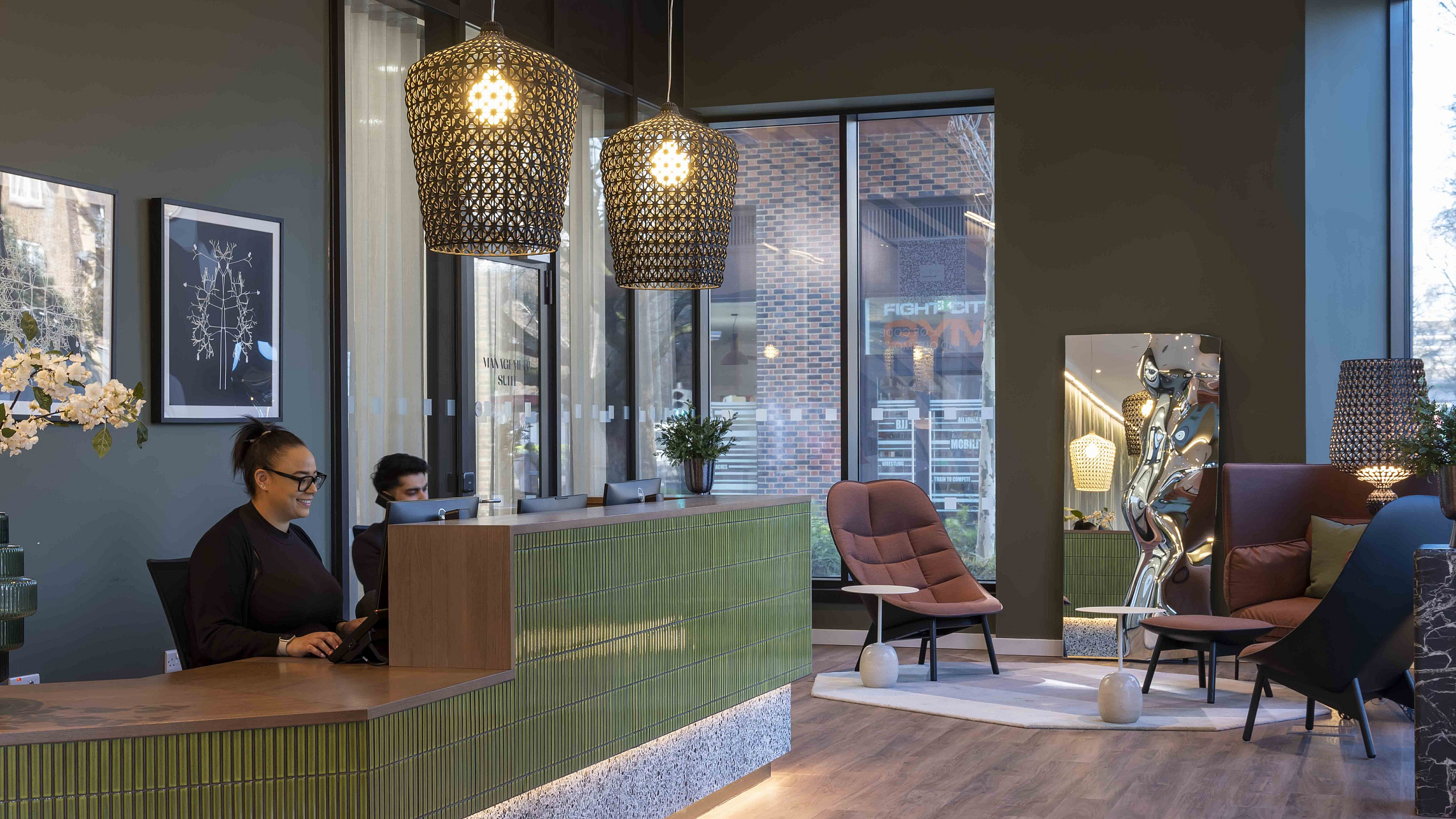 Welcoming apartment lobby with stylish decor, elegant seating, modern lighting, and a friendly reception area.