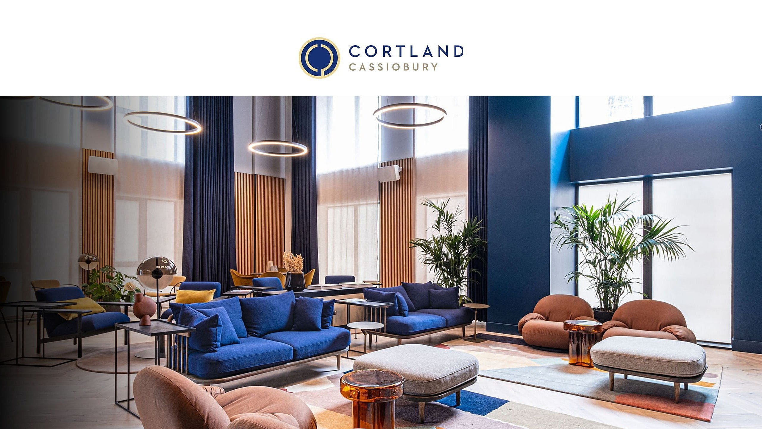 Bright and stylish room with floor-to-ceiling windows, elegant decor, and plush seating